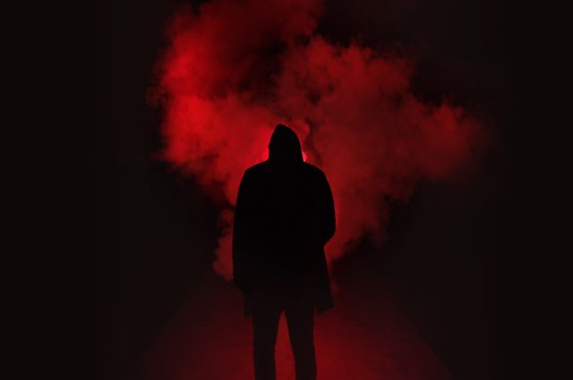silhouette-of-man-standing-against-black-and-red-background-333850